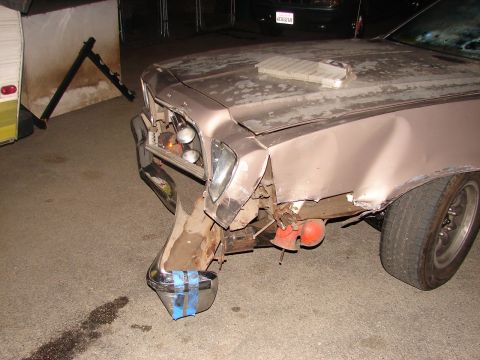 1973 Ford Ranchero - The front end of a 1973 Ford Ranchero shows significant damage, with the chrome bumper crudely repaired with blue tape.