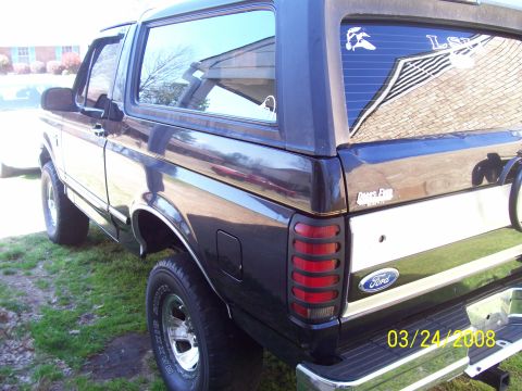 1994 Ford Bronco - The rear of a dark-colored Ford Bronco is shown, a white stripe and the Ford emblem. A date stamp reads 03/24/2008.