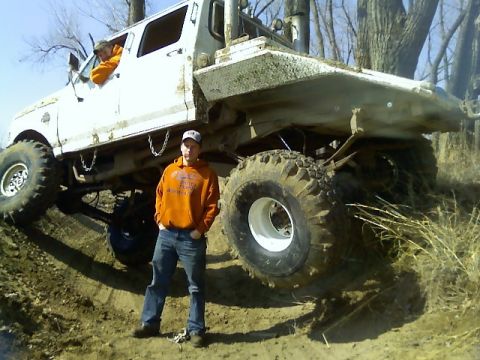 1992 Ford F-350 - Modified 1992 Ford F-350 pickup truck with oversized tires and a custom flatbed is shown off-road.