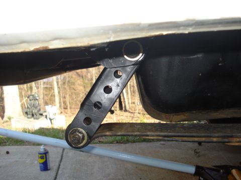 1996 Ford Bronco - Detail of a vehicle's rear suspension linkage, with a can of lubricant nearby.