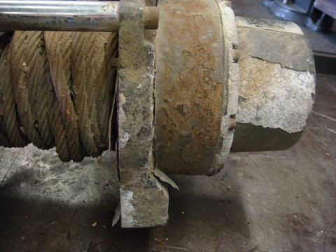 1996 Ford Bronco - This winch shows significant rust and wear on its metal components and cable.