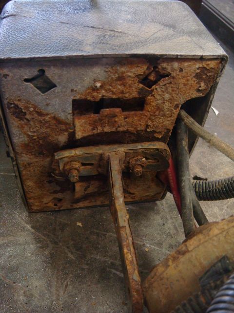 1996 Ford Bronco - Close-up of a corroded winch motor housing, showing significant rust damage and exposed electrical components.