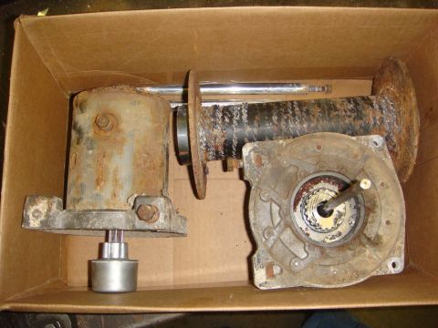 1996 Ford Bronco - Worn winch components, including a drum and gearbox, are shown disassembled inside a cardboard box.
