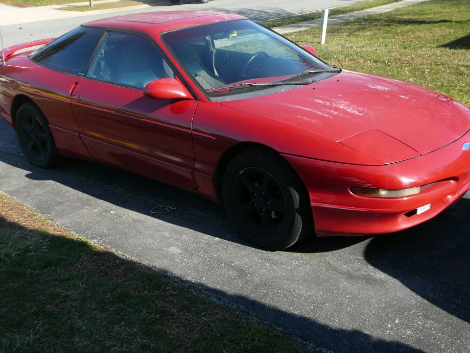 red 1994 Ford Probe parked on a driveway