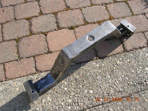 1996 Ford Bronco - Metal crossmember part shown on a paved surface.