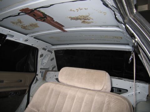 1991 Ford LTD Crown Victoria - The interior of a 1991 Ford Crown Victoria LTD shows signs of wear and tear with the headliner removed.