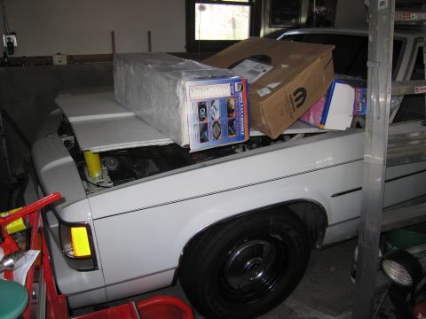 1991 Ford LTD Crown Victoria - White 1991 Ford Crown Victoria LTD in garage, hood open, carrying boxes and parts.