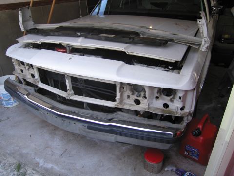 1991 Ford LTD Crown Victoria - Front end of a white 1991 Ford Crown Victoria LTD is disassembled, revealing the engine bay.