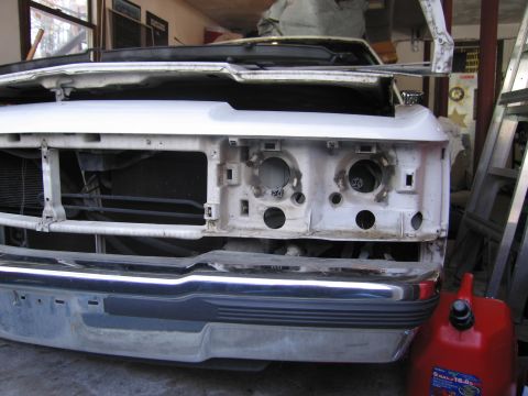 1991 Ford LTD Crown Victoria - Front view of a white vehicle undergoing repairs or restoration, with the hood raised.