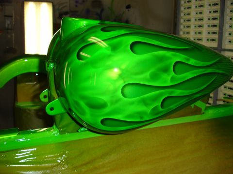 2006 Harley-Davidson FLHX - A bright green motorcycle fuel tank with custom flame graphics is shown, likely undergoing customization or repair.