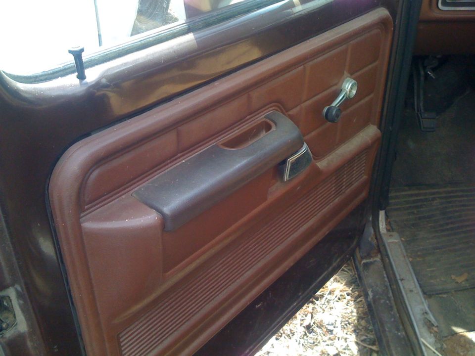 Reddish-brown interior door panel of an old Ford pickup