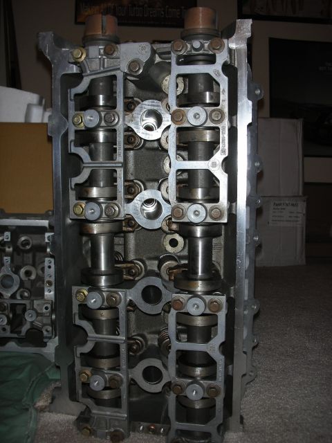 1998 Ford Crown Victoria - aluminum cylinder head stands upright, exposing camshaft bearing caps and the valvetrain assembly.