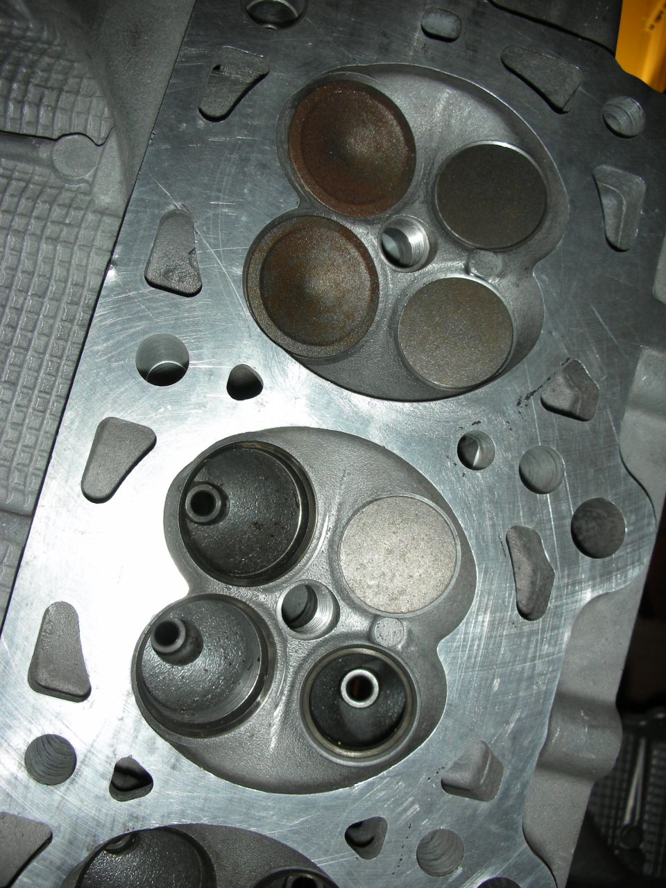 Close-up of two combustion chambers on an aluminum cylinder head