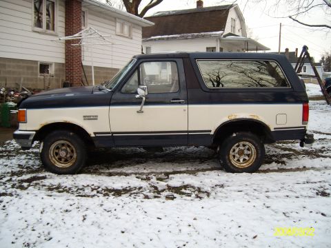 1988 Ford Bronco - 1988 Ford Bronco parked in a snowy yard.