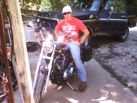 1979 Ford Bronco - A man sits on a motorcycle in front of a black 1979 Ford Bronco with its driver's door open.