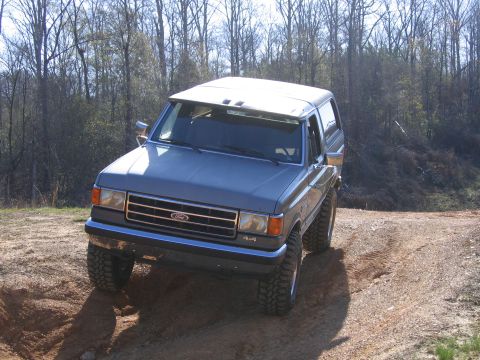 1989 Ford Bronco - This 1989 Ford Bronco navigates an off-road trail, its 4x4 capabilities.