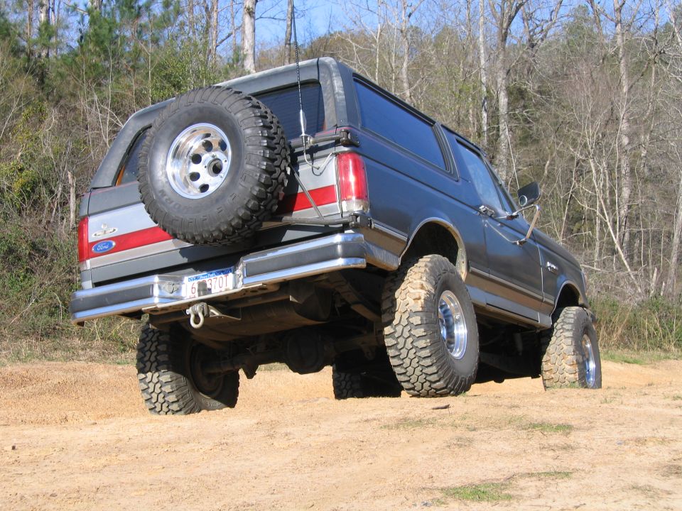 Ford Bronco on dirt with spare tire on back. License plate reads 6 B 3701