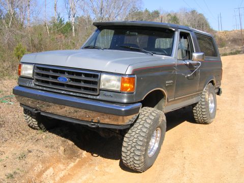 1989 Ford Bronco - This lifted 1987 Ford Bronco is equipped with large off-road tires and a sun visor.