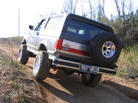 1989 Ford Bronco - This 1989 Ford Bronco is captured from the rear as it navigates a dusty off-road trail.