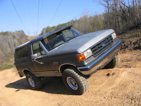 1989 Ford Bronco - This 1989 Ford Bronco is navigating a dirt path on an incline.