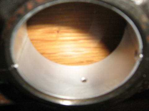 1981 Dodge Power Ram - A close-up view of a metal engine bearing, showing its internal surface and a small oil hole.