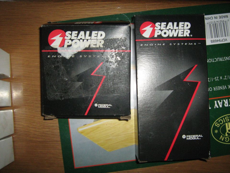 Two Sealed Power Engine Systems parts boxes by Federal-Mogul on a wood table