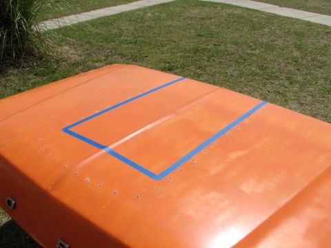 1979 Ford Bronco - The hood of a 1979 Ford Bronco is shown with blue tape outlining a section.