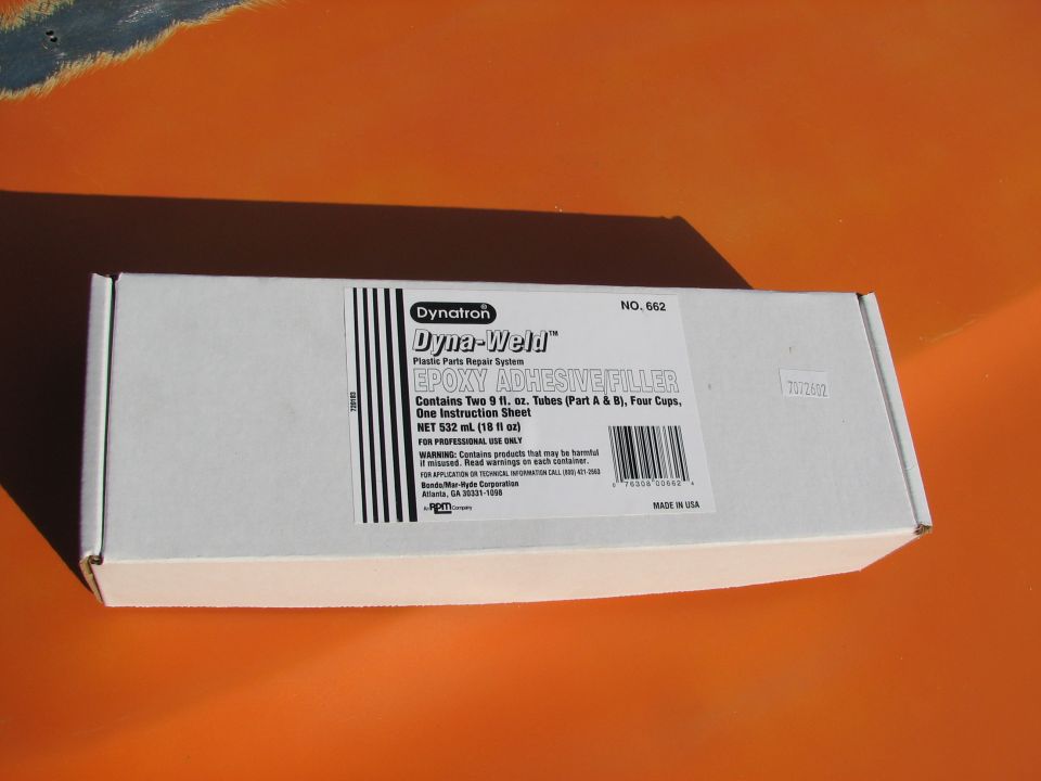 Box of Dynatron Dyna-Weld 662 epoxy adhesive filler on an orange painted panel