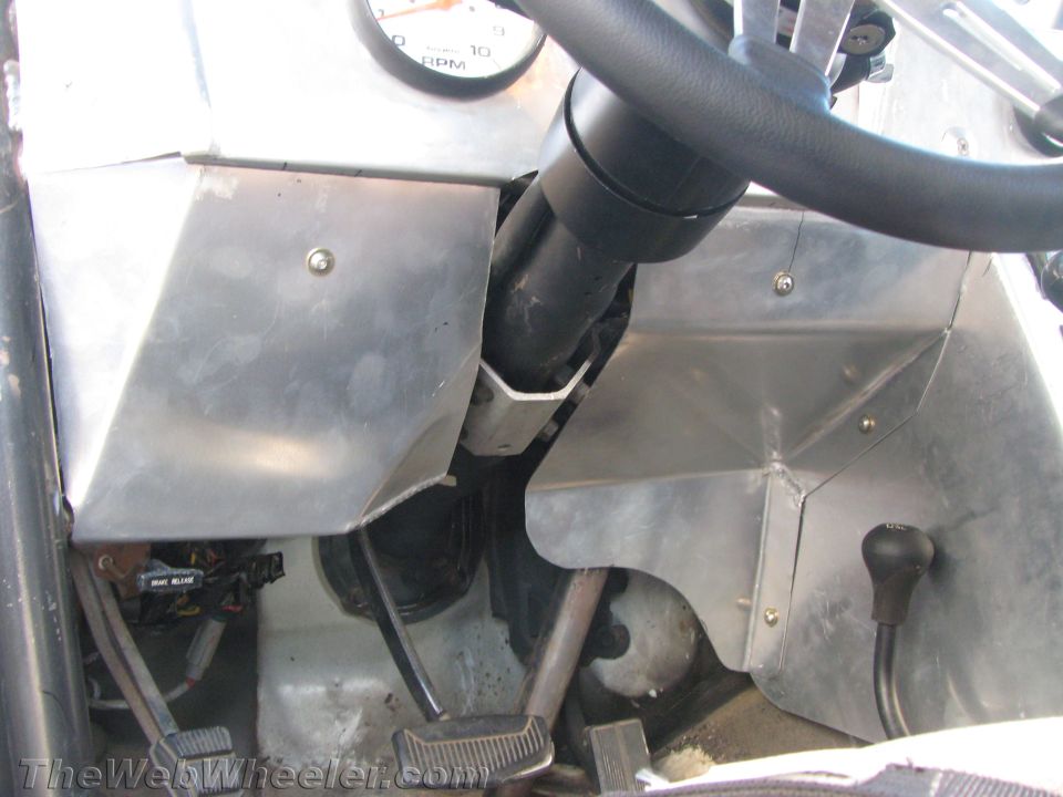 Bare-metal vehicle cabin with steering column, pedals and aluminum panels