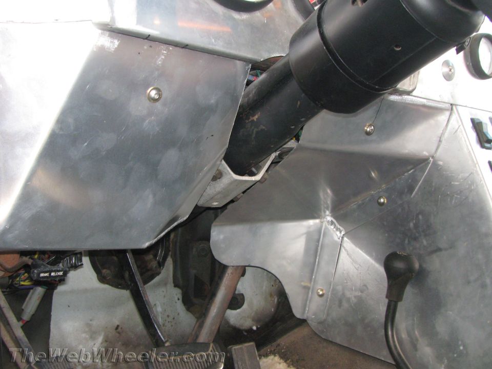 Close-up of steering column, shifter and aluminum panels inside a custom cabin