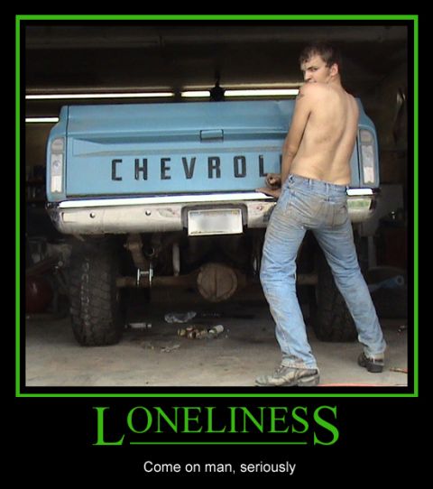 1984 Ford Bronco - A man stands next to the rear of a blue Chevrolet pickup truck in a garage.