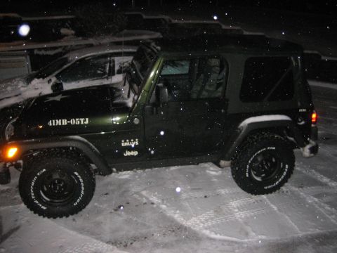 1993 Ford Bronco - A green Jeep Wrangler is parked in the snow, displaying 'Willys Jeep' badging and '41MB-05TJ' text on its side.