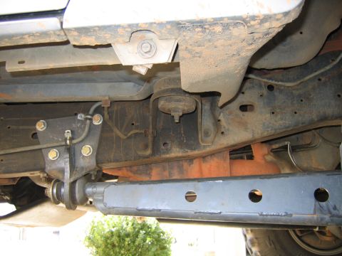 1989 Ford Bronco - Close-up of the undercarriage, focusing on the frame and suspension system.