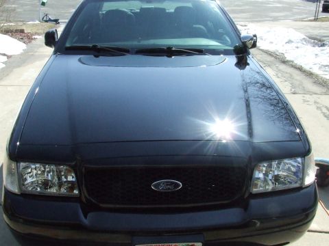 2003 Ford Crown Victoria - Front view of a black 2003 Ford Crown Victoria parked on a driveway.