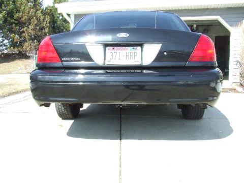 2003 Ford Crown Victoria - Black 2003 Ford Crown Victoria parked in a driveway, showing the rear bumper and taillights.