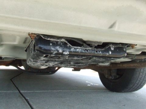 2003 Ford Crown Victoria - The undercarriage of a vehicle is visible, with focus on the frame and exhaust components.