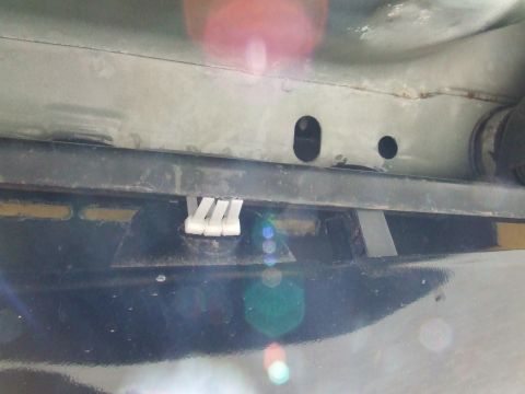 2003 Ford Crown Victoria - White plastic clips are visible on a dark underbody panel, with a Supermotors.net watermark at the bottom right.