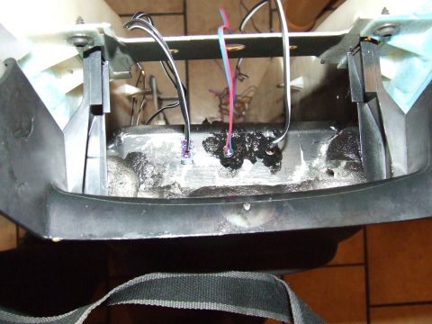 2003 Ford Crown Victoria - Close-up view of exposed wiring and metal components within a vehicle's interior.