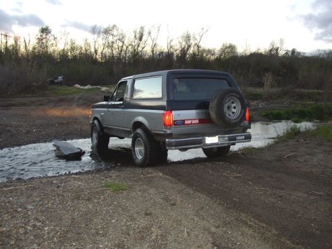 1989 Ford Bronco - This 1989 Ford Bronco is captured from the rear as it navigates through a shallow stream.