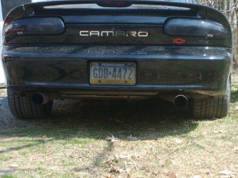 2002 Chevrolet Camaro - The rear of a black Chevrolet Camaro is shown, dual exhaust pipes and a spoiler.