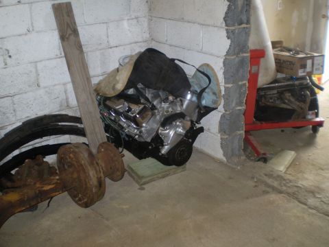 2005 Ford Excursion - V8 engine on a stand, with other parts in a storage area.