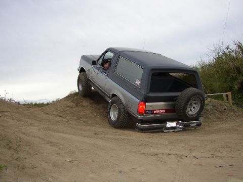 1989 Ford Bronco - This 1989 Ford Bronco is shown off-road, ascending a sandy incline.