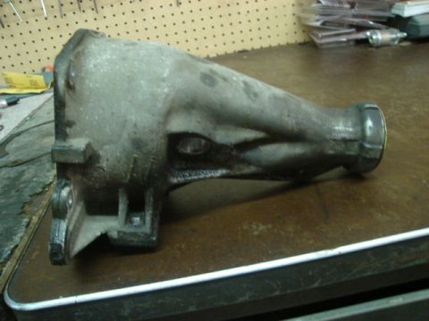 2000 Ford Crown Victoria - A transmission housing sits on a workbench, showing signs of wear and tear.