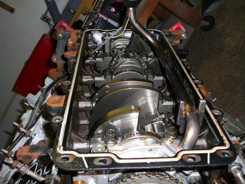 1997 Mercury Grand Marquis - Close-up view of an engine's internal components, including the crankshaft and oil pan area.