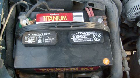 1995 Ford C-150 (Centurion Conversions) - Car battery with Autocraft Titanium branding and safety warnings visible.