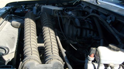 1995 Ford C-150 (Centurion Conversions) - View of the engine compartment, dual air intake tubes and various engine components.