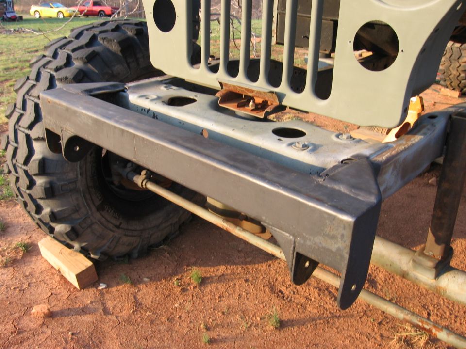 Front bumper and grille of a 1980 Jeep CJ7 with large tires