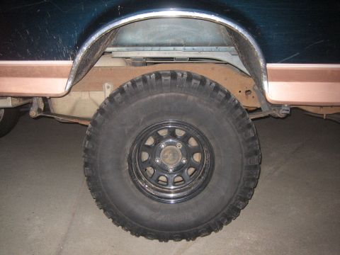 1995 Ford Bronco - Close-up view of the rear wheel and fender area of an older SUV.