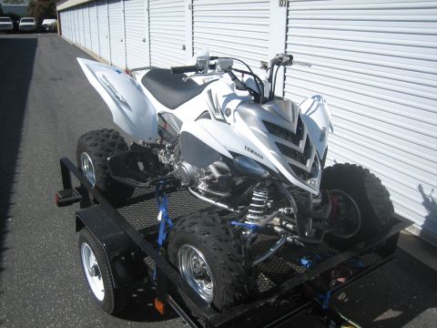 1995 Ford Bronco - White Yamaha ATV secured to a trailer, ready for transport.