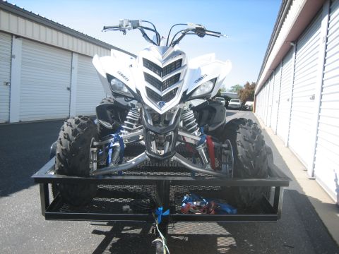 1995 Ford Bronco - White Yamaha ATV on a trailer, front view, with storage units in the background.